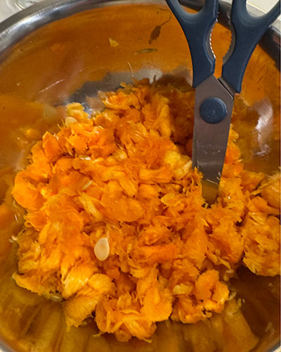 Pumpkin guts from jack-o'lantern with a pair of scissors to cut them down.