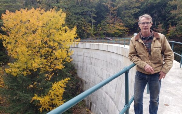 Robert King stands atop a dam
