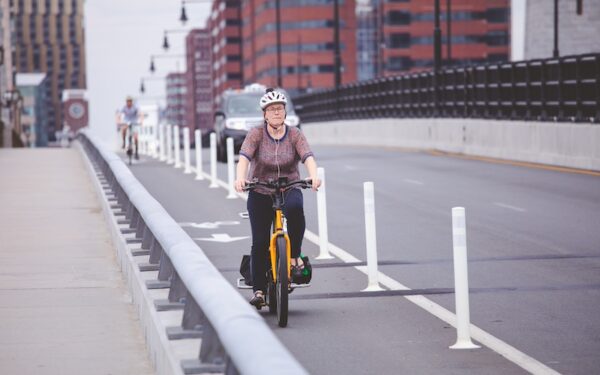 A woman bikes in a bike lane in Boston