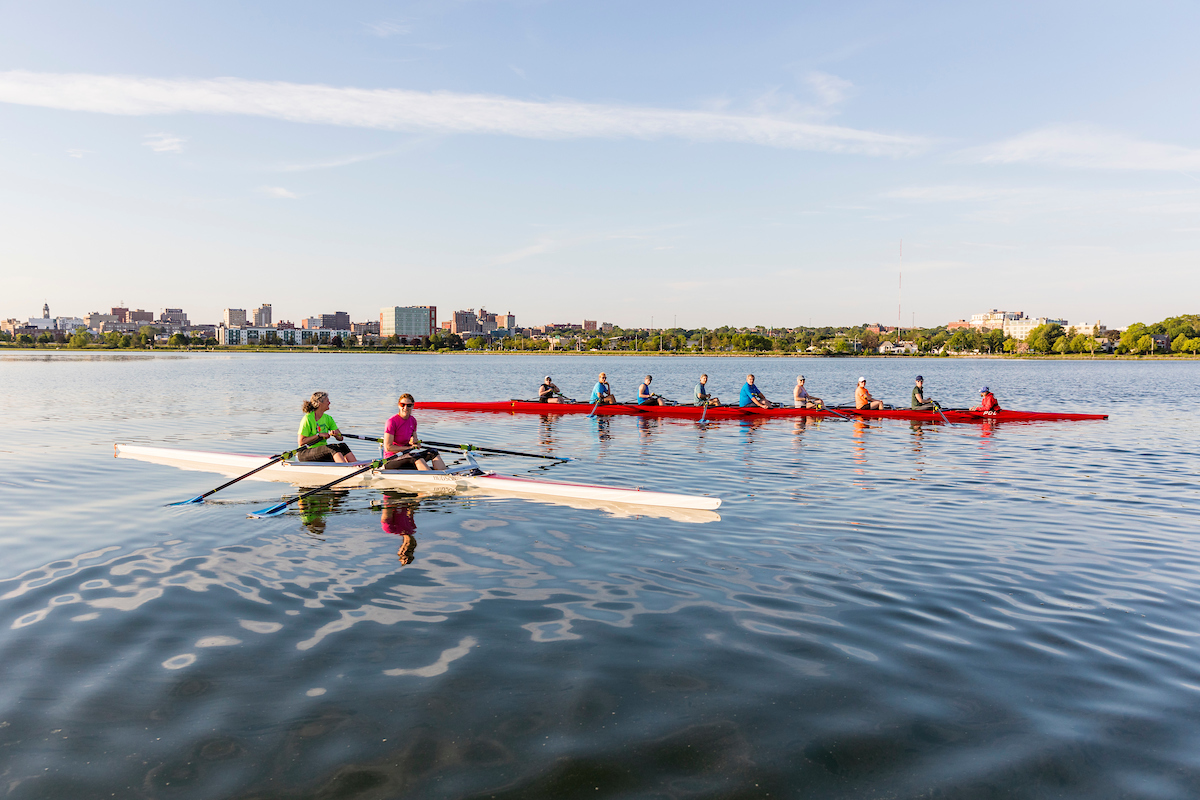 A morning rowing club (Portland Community Rowing Association) rows in Back Cove in Portland, Maine.