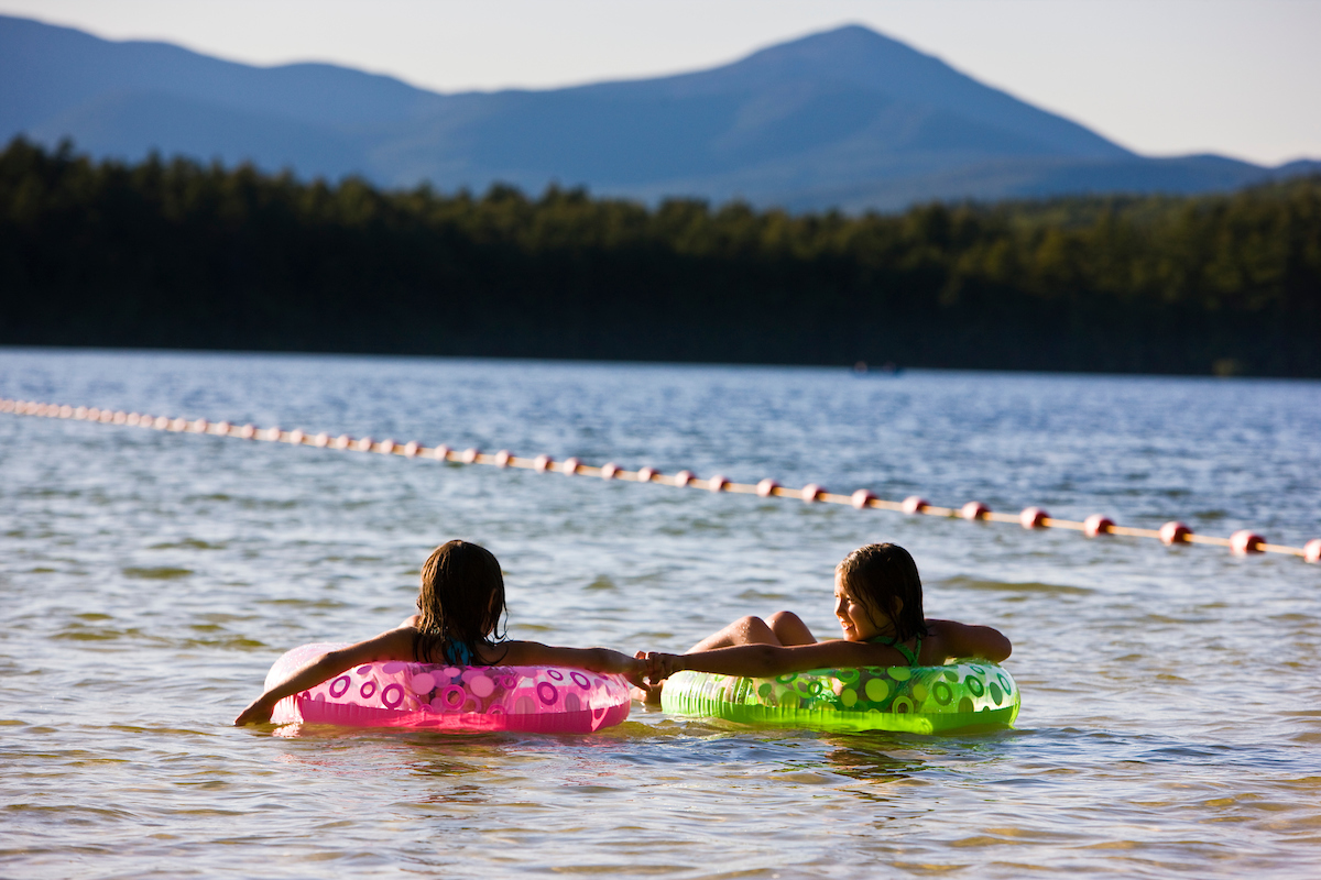 Kids float at the beach at White Lake State Park in Tamworth, New Hampshire.