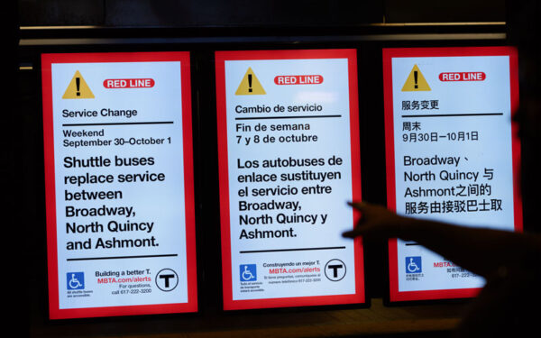 Service change signs on the MBTA red line. Signs announce several service closures between September and October. 