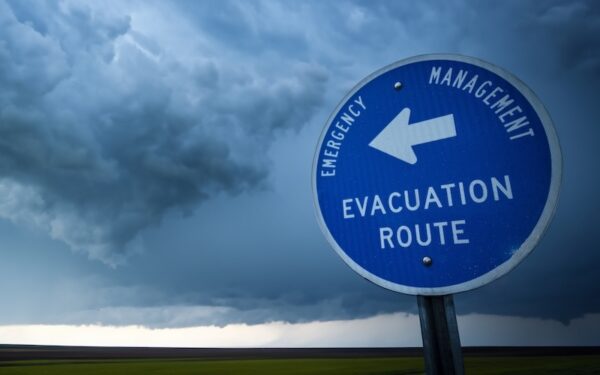 storm clouds behind an evacuation route sign