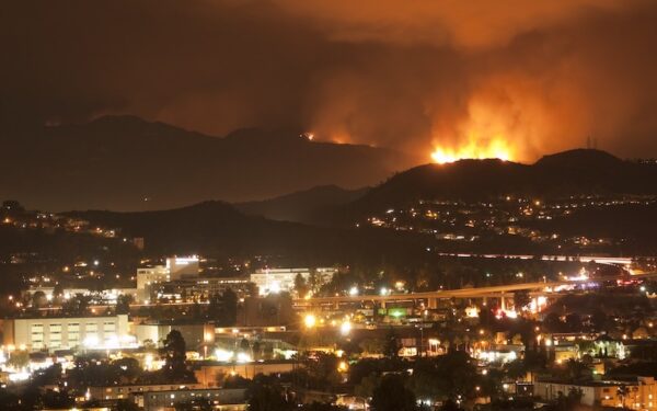 flames on a hillside overlooking Los Angeles