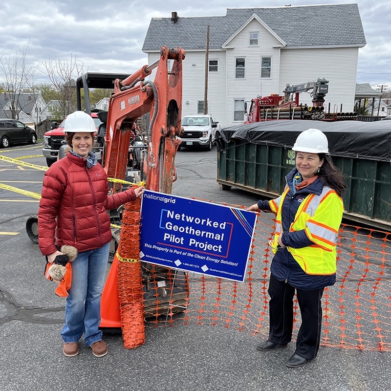 Zeyneb Magavi holding a sign that says Networked Geothermal Pilot Project