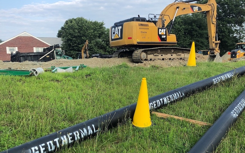 geothermal pipes lying in green grass