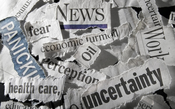 A collage of news headline cutouts with one word, such as "news," "uncertainty," "economic turmoil," and "oil."